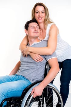 young disabled man in wheelchair and his wife