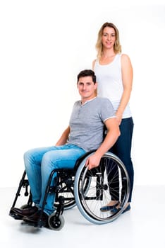 young disabled man in wheelchair and his wife