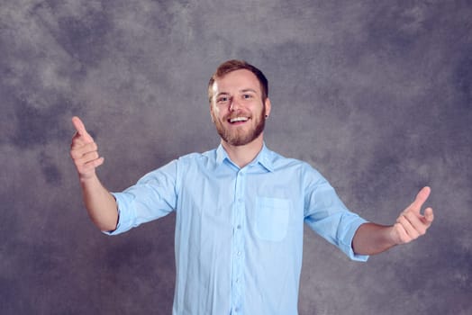 young bearded man is surprised and showing open hands