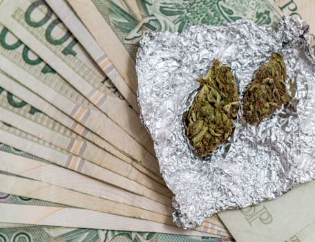 marijuana in tin foil with pipe and polish pln money background