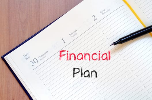 Financial plan text concept write on notebook