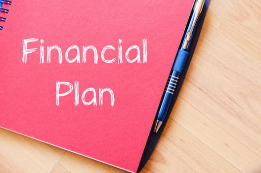 Financial plan text concept write on notebook