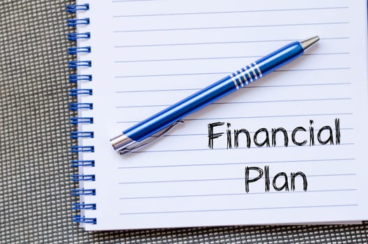 Financial plan text concept write on notebook