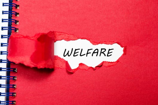 The word welfare appearing behind torn paper