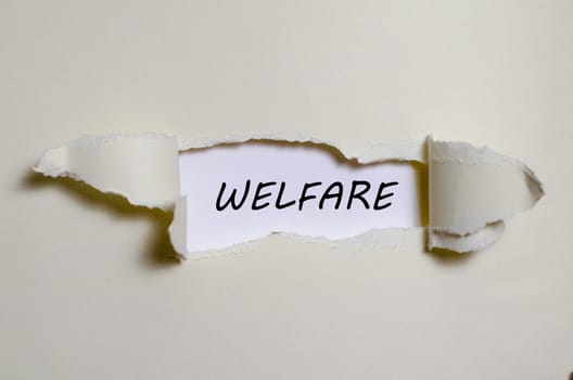 The word welfare appearing behind torn paper