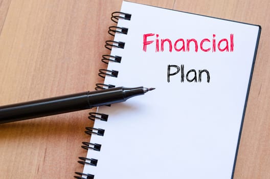 Financial plan text concept write on notebook