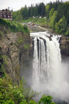 A large flow of water travels over the ridge creating a waterfall