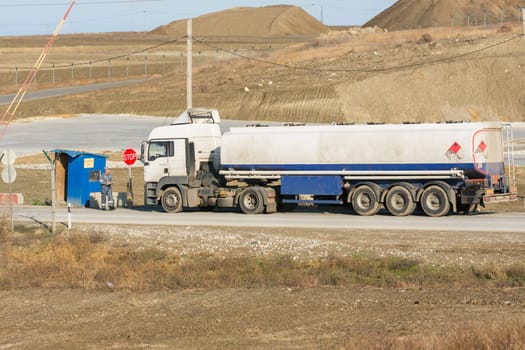 Taman, Russia - November 5, 2016: Verification of documents from the driver tank truck at security checkpoint protected area