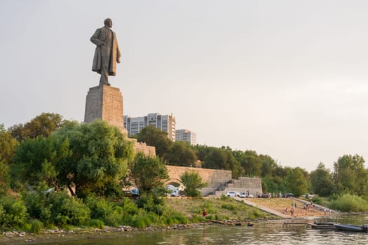 Volgograd, Russia - August 1, 2016: View of the sunset on the promenade and a statue of Lenin in the Krasnoarmeysk district of Volgograd