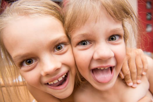 Close-up portrait of two girls five and seven years