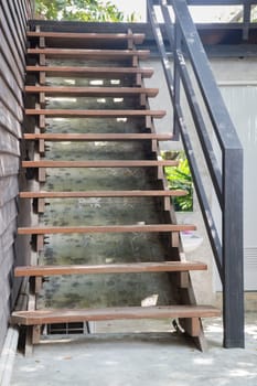 Exterior brown wooden staircase with iron banister, stock photo