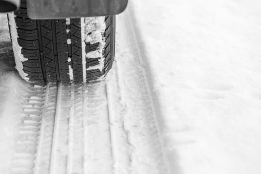 Car tire on snowy winter road