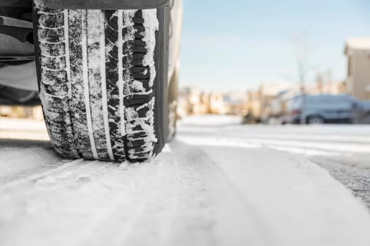 Car tire on snowy winter road
