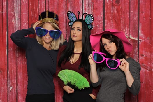 Queen and fine ladies in front of a photo booth