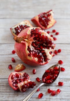 Open fresh ripe pomegranates on wooden background