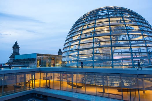 Illuminated glass dome on the roof of the Reichstag in Berlin in the late evening.