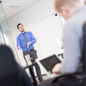 Workplace in modern office with business people brainstorming. Businessman working on laptop during the meeting.