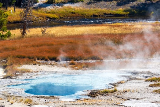 Pool with steam coming off of it in the Upper Geyser Basin in Yellowstone National Park
