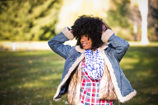 ethnic woman wearing fashion fall outfit outdoors int he park