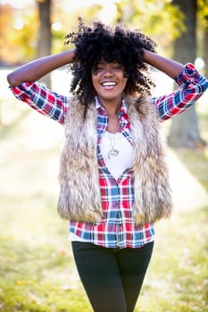 ethnic woman wearing fashion fall outfit outdoors int he park