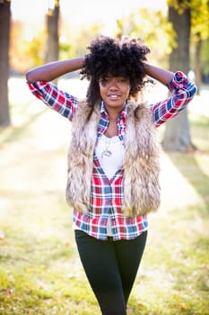 ethnic woman wearing fashion fall outfit outdoors int he park