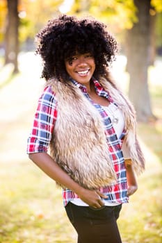 ethnic woman wearing fashion fall outfit outdoors int he park