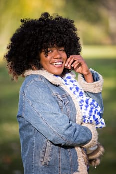 ethnic woman wearing fashion fall outfit outdoors int he park