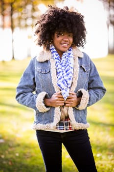 ethnic woman wearing fashion fall outfit outdoors int he park