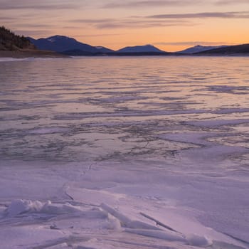 Square Abraham Lake Sunrise Landscape, with textured snowy foreground, Alberta Canada.