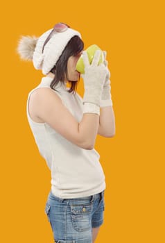 pretty young brunette woman with a cup of tea on yellow background