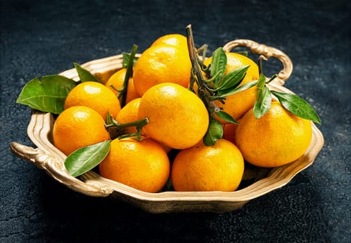 Tangerines on a round platter and texture background