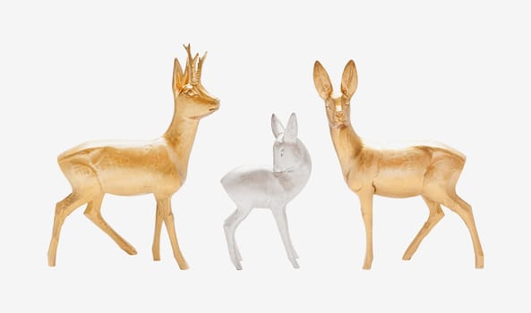 Male, female and young deer in gold and silver color carved in wood isolated