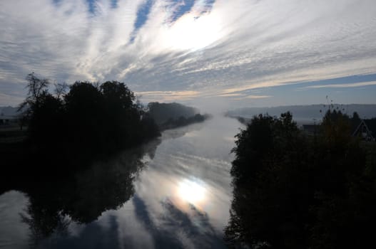 view taken on a bridge towards the Alps