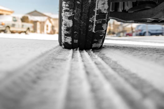 Car tire on snowy winter road