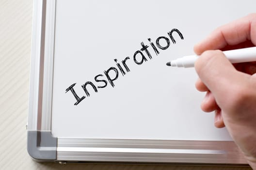 Human hand writing inspiration on whiteboard