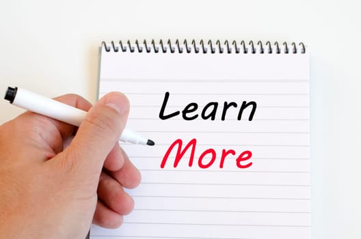 Learn more text concept write on notebook