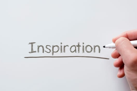 Human hand writing inspiration on whiteboard