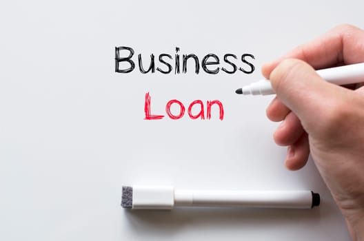 Human hand writing business loan on whiteboard