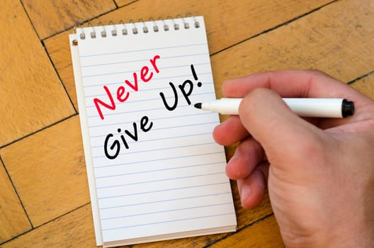 Never give up text concept write on notebook