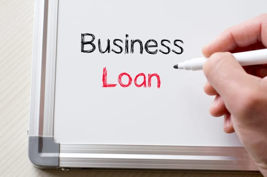 Human hand writing business loan on whiteboard