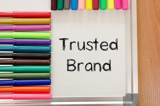 Trusted brand text concept over whiteboard background