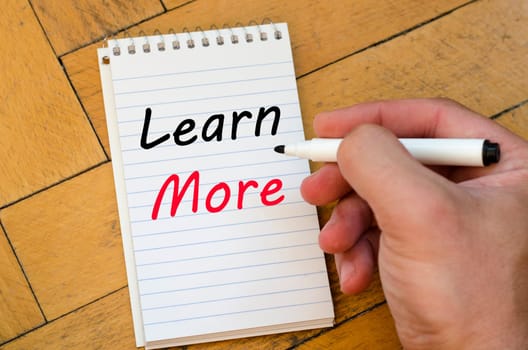 Learn more text concept write on notebook