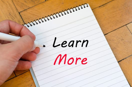 Learn more text concept write on notebook