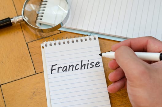 Franchise text concept write on notebook