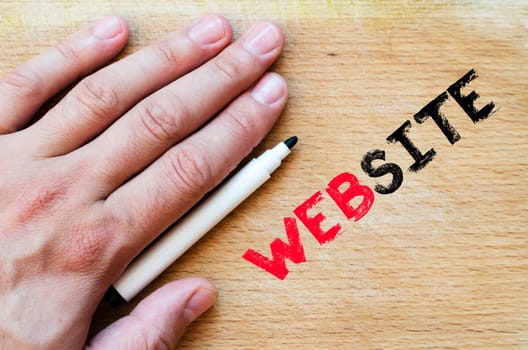 Human hand over wooden background and website text concept