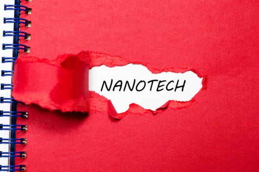 The word nanotech appearing behind torn paper
