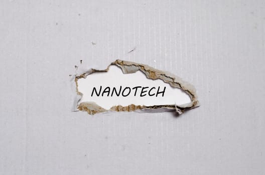 The word nanotech appearing behind torn paper