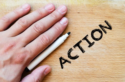Human hand over wooden background and action text concept
