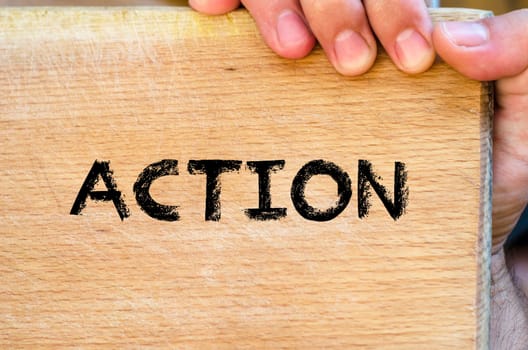Human hand over wooden background and action text concept