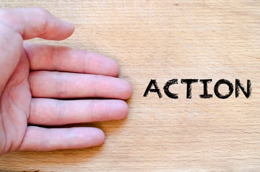 Human hand over wooden background and action text concept